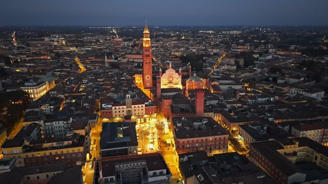 Evening sunset aerial view of Cremona, Lombardy, Italy. Cathedral Assumption of the Blessed Virgin Mary and tower bell in Cremona. Aerial evening view