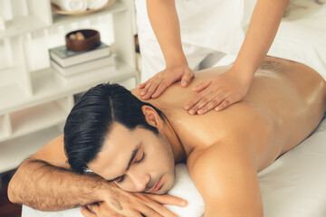 Caucasian man customer enjoying relaxing anti-stress spa massage and pampering with beauty skin...