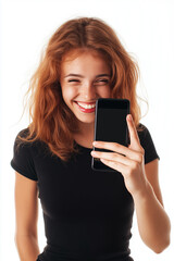 Fototapeta premium Young woman showing a smartphone screen, smiling and winking at the camera, isolated on a white background.