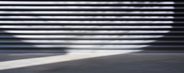 Abstract image of light and shadow created by horizontal lines, showcasing a contrast between bright and dark areas on a surface.
