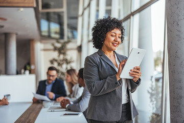 Professional Businesswoman Using Tablet in Modern Office Setting