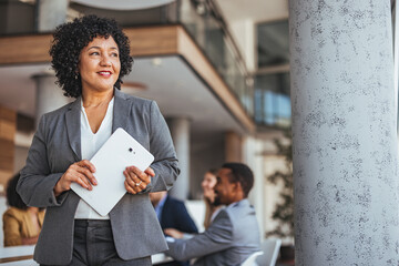Confident Businesswoman Holding Tablet at Modern Office Meeting