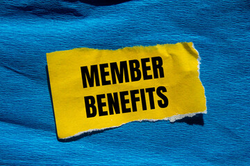 Member benefits message written on ripped torn yellow paper piece with blue background. Conceptual...