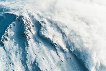 aerial view of an avalanche in the mountains carving its path down a steep slope, with snow billowing into the air, minimal background with copy space