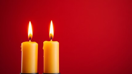 Elegant trio of flaming candles with warm yellow glow, set against deep red and black 