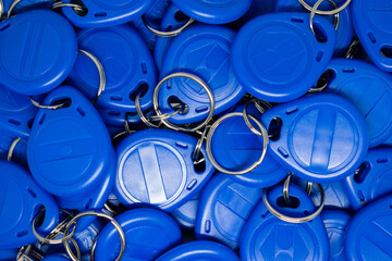 Blue electronic component RFID key fobs. Proximity keychains, selective focus