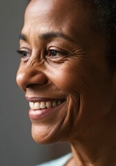 Fototapeta premium Smiling mature African -American female with wrinkles highlighting joy and experience