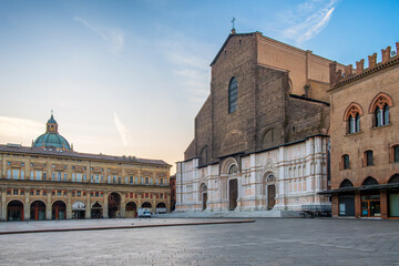 Bologna old town with Piazza Maggiore, Emilia Romagna, Italy. Basilica of San Petronio with Palazzo dei Banchi and Dome of the Basilica of San Pietro on main city square at sunrise with nobody © samael334
