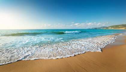 Gentle waves rolling over smooth sandy shores on a beautiful summer day