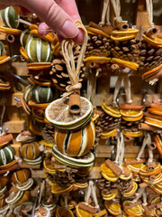 Aromatic handmade decoration made of dried citrus fruits slices and cinnamon on a Christmas market close up