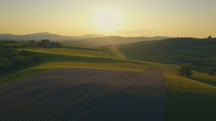 Golden Sunset Over Tuscan Countryside: Rolling Hills and Agricultural Fields
