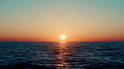 Obraz premium The sun is setting over the ocean