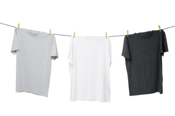 Three plain t-shirts in gray, white, and dark gray hanging on a clothesline with green clips on a clean white background, concept of clothing