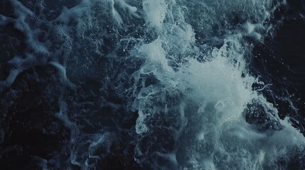 A close-up view of turbulent ocean waves creating splashes and foam.
