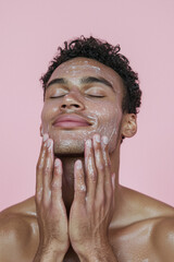 handsome young man applying skin care on his face
