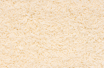 Macro photography of desiccated coconut, shredded, raw; ketogenic diet, healthy vegan food; natural ingredient; dry coconut flakes