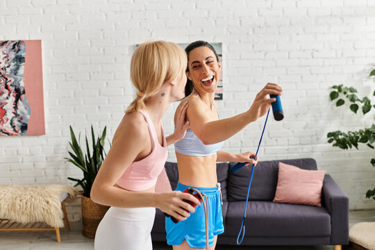 Young couple enjoying a fun workout together in a cozy living room space - Powered by Adobe