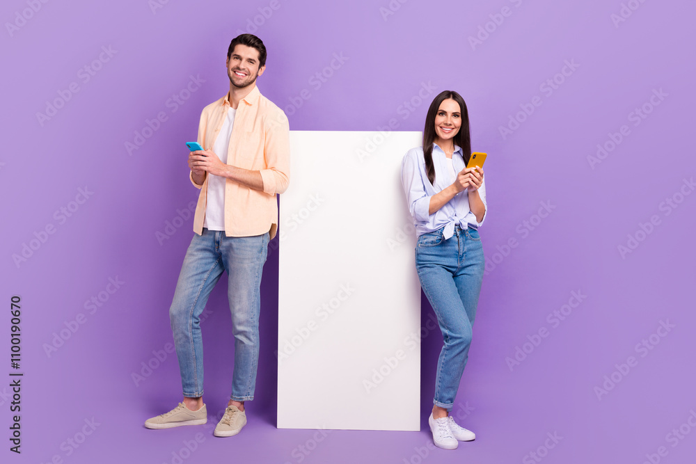 Poster full size portrait of two nice cheerful people use smart phone big empty space poster isolated on pu