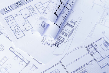 Construction plan. Scheme drawing rolled up in a roll. Home renovation planning..