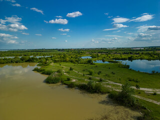 Aerial view with a delta, an ecosystem full of lakes and green willows. Amazing wild landscape seen from above in summer on a sunny day