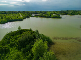 Obraz premium Aerial view with a delta, an ecosystem full of lakes and green willows. Amazing wild landscape seen from above in summer on a sunny day