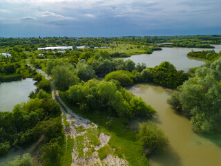 Fototapeta premium Aerial view with a delta, an ecosystem full of lakes and green willows. Amazing wild landscape seen from above in summer on a sunny day