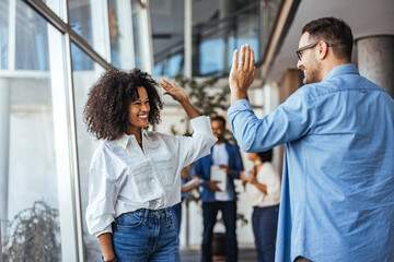 Two Colleagues Celebrating Success with a Joyful High Five