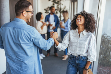 Joyful Business Colleagues Celebrating Success in Modern Office