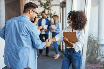 Professional Handshake Between Colleagues in Modern Office Setting