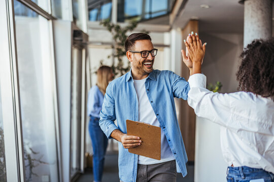 Colleagues High-Fiving for Successful Business Collaboration
