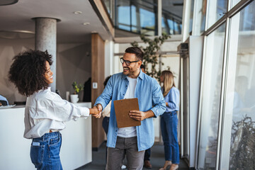 Colleagues Greeting Each Other with Handshake in Office