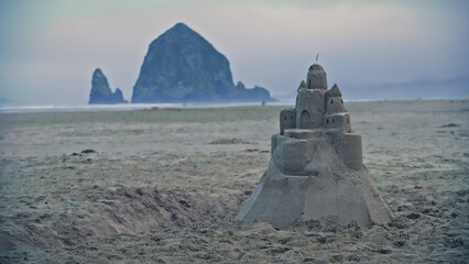 Tall sandcastle on Oregon coast beach, wide shot