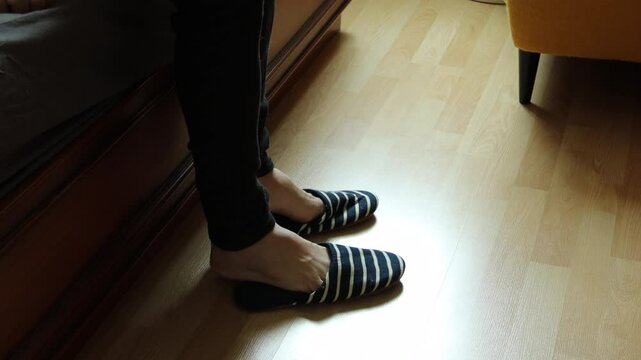 The senior Asian man with bandages on his left hand trying to do normal work at home.