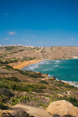 Fototapeta premium Aerial panoramic beach view of Ramla bay from Tal-Mixta Cave on a sunny day. Gozo island. Malta