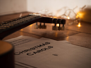 Acoustic guitar in front of Christmas lights 