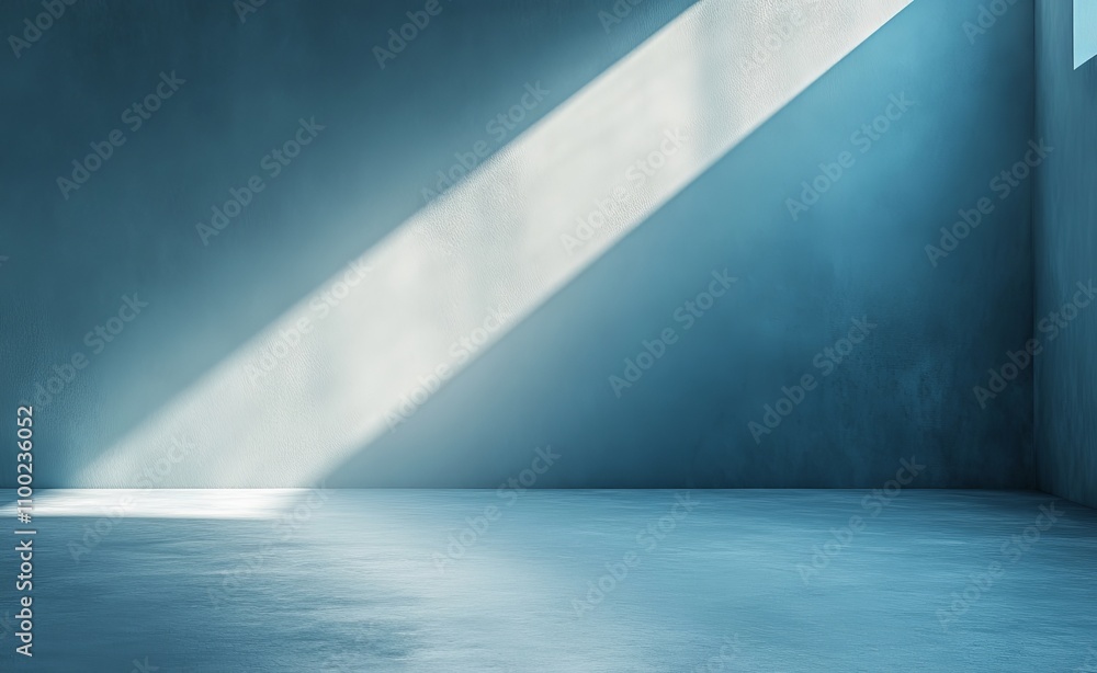 Poster sunlight streams through an empty room, creating a serene play of light and shadow on the cool concr