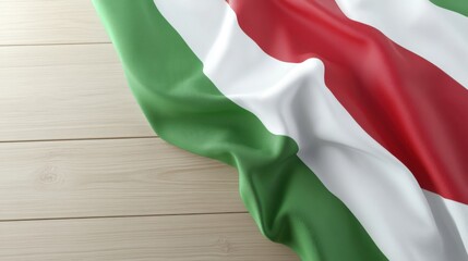 Obraz premium A close-up of a flag with green, white, and red stripes, draped over a wooden surface, highlighting its texture and colors.
