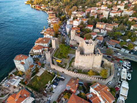 Aerial view of the historic anadolu hisari fortress along the bosphorus with clear blue water and scenic boats, Anadolu Hisari, Turkey.