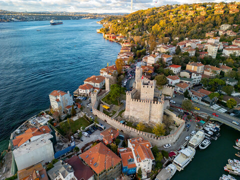 Aerial view of anadolu hisari fortress along the bosphorus with picturesque houses and boats, istanbul, turkey.