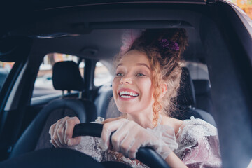 Joyful young woman driving a modern vehicle with a smile, embodying a seamless blend of historical...
