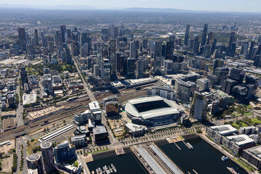 Aerial view of marvel stadium and urban skyline with waterfront in sunny daytime, Docklands, Melbourne, Australia.