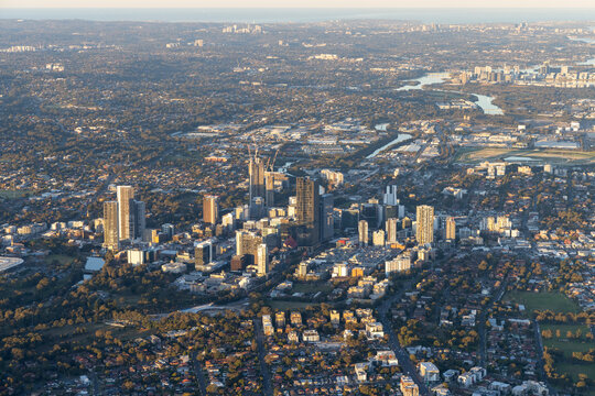 Aerial view of sprawling cityscape with modern highrise buildings and a river, South Wentworthville, Australia.