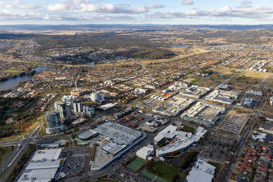 Aerial view of urban landscape with modern buildings and roads under a scenic sky, Gungahlin, Australia.