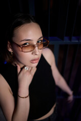 A stylish woman struts into the bar at night, exuding elegance and seduction of nightlife