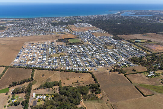 Aerial view of suburban homes and farmland along the coastline, Marcus Hill, Australia.