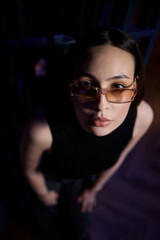 A stylish woman struts into the bar at night, exuding elegance and seduction of nightlife