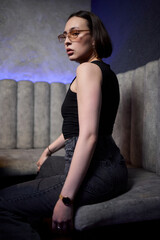 A stylish woman struts into the bar at night, exuding elegance and seduction of nightlife