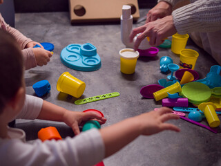 Children engage in creative play with colorful modeling clay and plastic tools, shaping imaginative designs. Plastic tools assist in developing fine motor skills, making playtime fun 