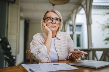 worried woman have contact less payment scan bill on mobile phone