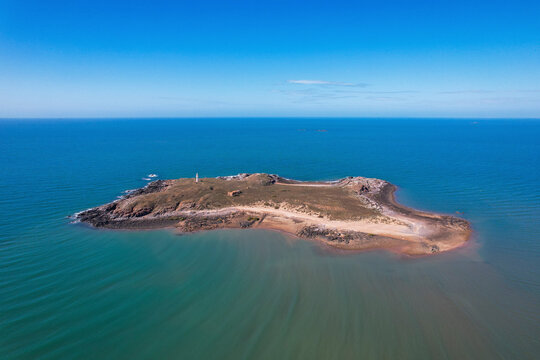 Aerial view of Jarman Island with a lighthouse surrounded by tranquil ocean, Cossack, Australia.